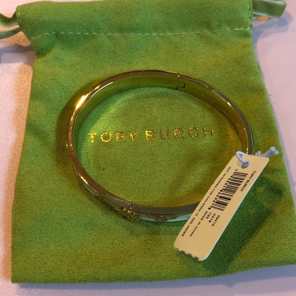 Authentic Tory Burch New/tag and pouch. Enamel Floral Hinge gold tone bracelet.